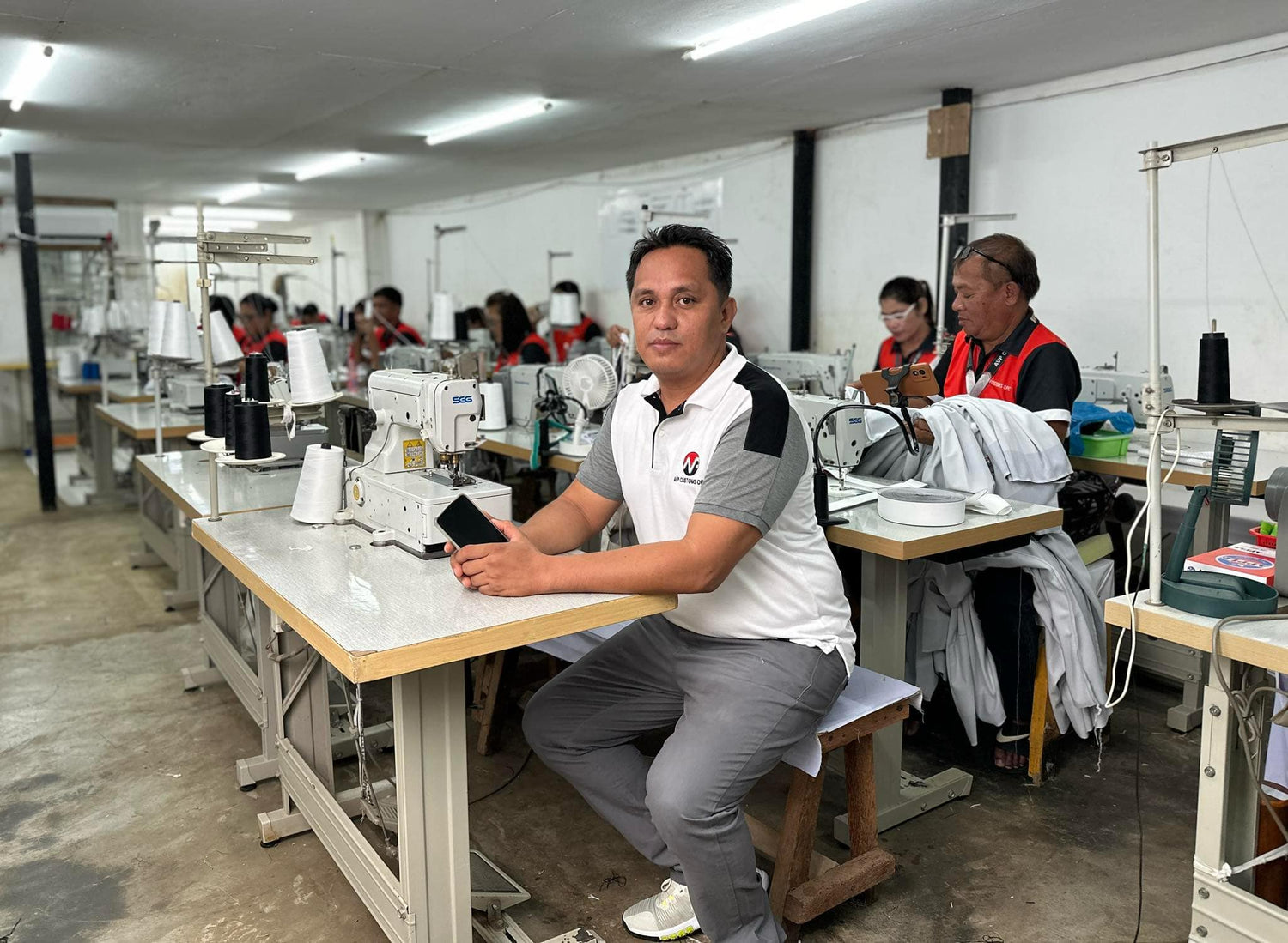 Founder of AVP Custom Prints standing inside the printing studio